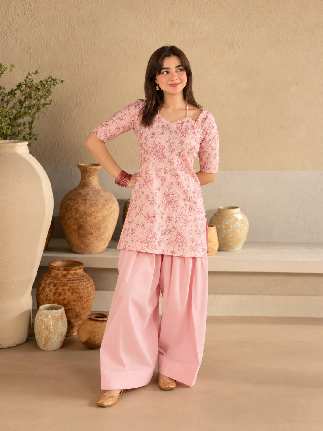 Bahaar Bloom pink floral crepe shirt with plain wide-leg trousers, standing waist view.