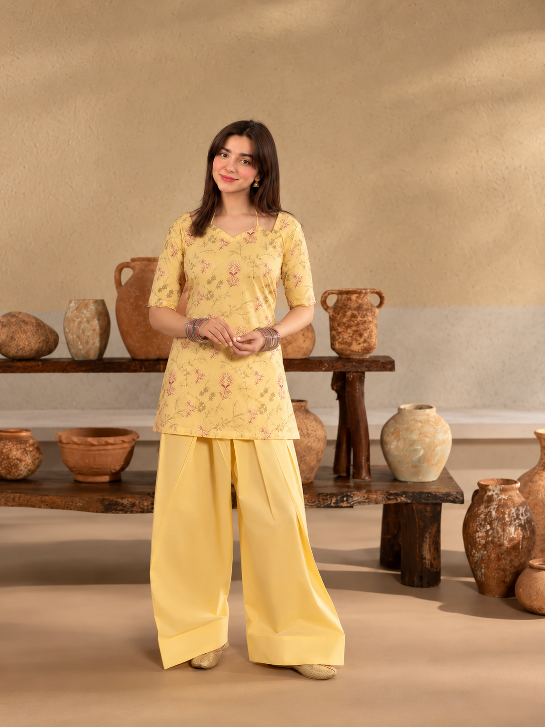 Basant Bloom butter-yellow printed crepe shirt and plain palazzo trousers, relaxed standing view.