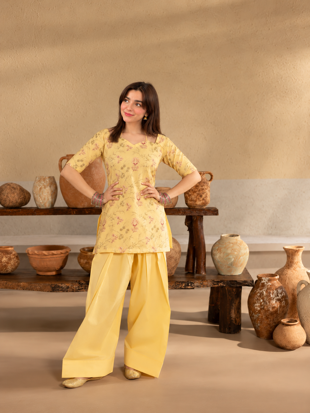Basant Bloom butter-yellow printed crepe shirt and plain palazzo trousers, side gaze view.