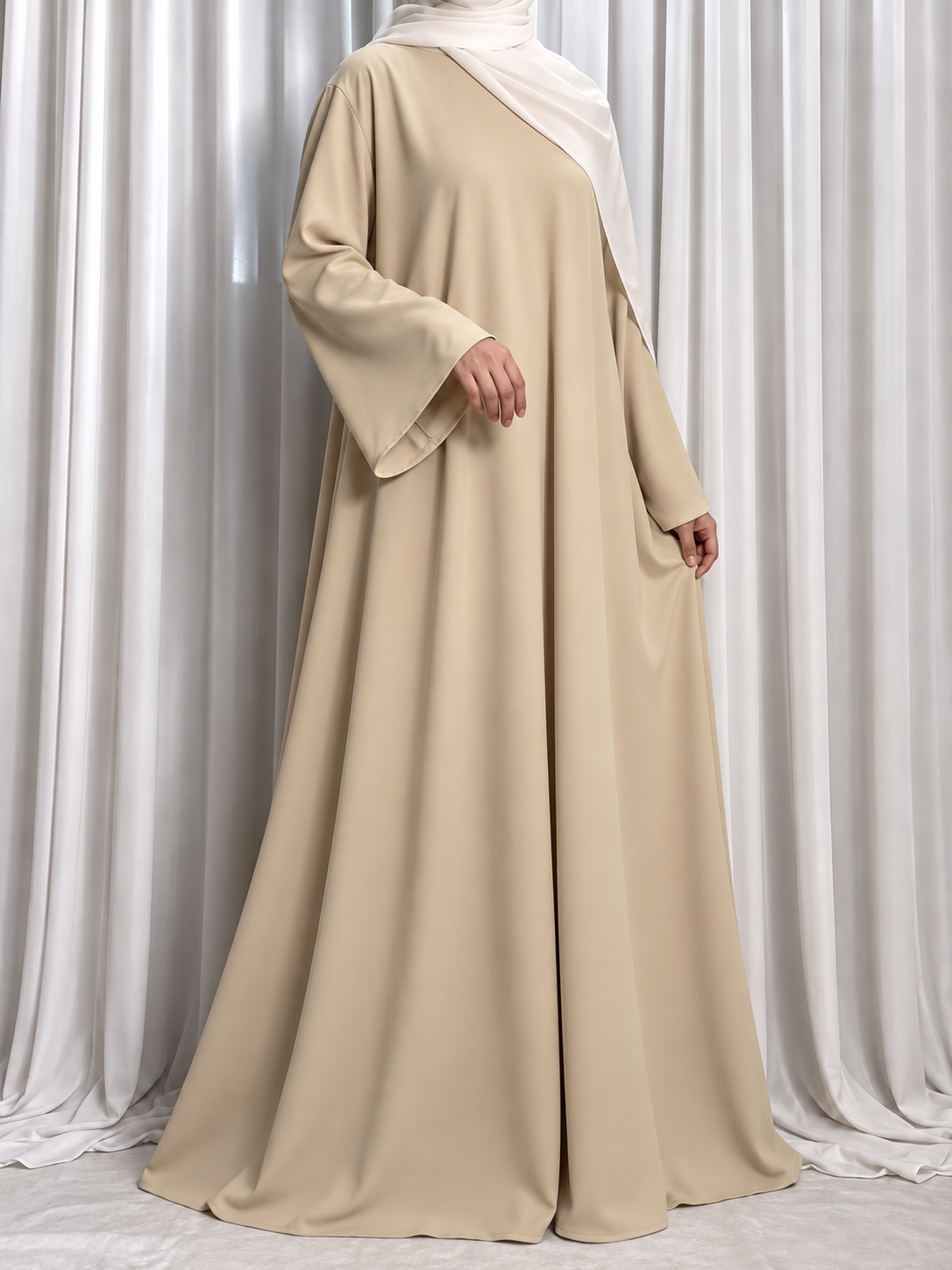 Nazakat Abaya in Beige Nida fabric, three quarter view. Abaya only; hijab not included.