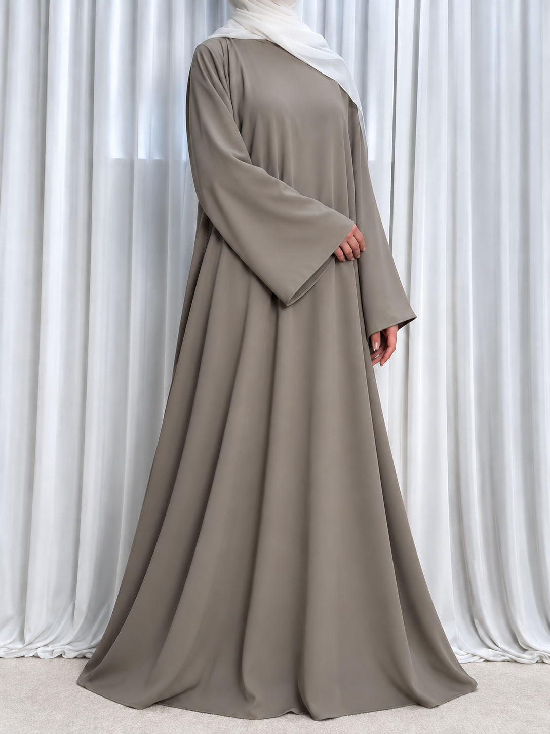 Nazakat Abaya in Warm Grey Nida fabric, three quarter view. Abaya only; hijab not included.